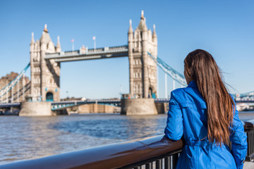 London tourist city travel woman enjoying view of Tower Bridge. Urban lifestyle tourism Europe destination vacation person enjoying view of famous attraction, England, Great Britain, UK.