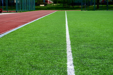 Fototapeta na wymiar football field with artificial turf, angle, background