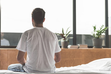 Serene man relaxing in bedroom
