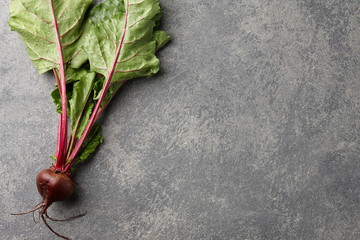 Fresh harvested beetroot on stone background, top view