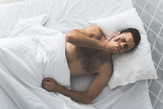 Exhausted male person wants to have a nap