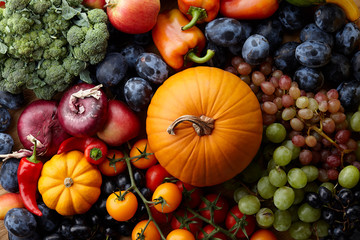 Autumn harvest concept. Seasonal fruits and vegetables on a wooden table, top view