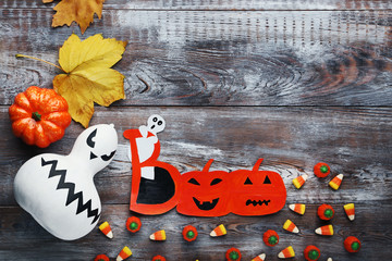 Halloween candies with pumpkin on brown wooden table