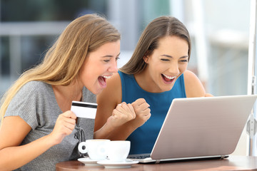 Excited friends discovering offer buying on line