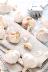 Garlic with napkin on blue wooden table