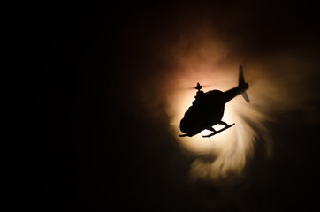 Helicopter over fire sunset horizon. War concept. Military scene of flying helicopter fire backgroung effect. Decoration © zef art