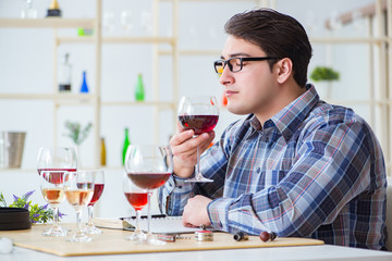 Professional sommelier tasting red wine 