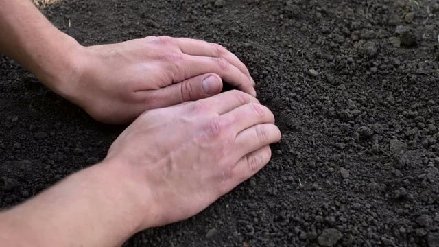 Male hand touching the ground, checking quality, slow motion