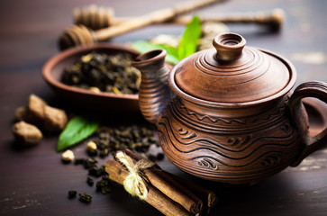 Dry tea leaves in a spoon on an old background