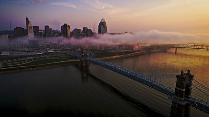 Early morning low clouds hovering over a bridge in Cincinnati, Ohio - obrazy, fototapety, plakaty