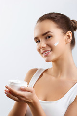 Skincare. Beauty Concept. Young Pretty Woman Holding Cosmetic Cream.Girl wiht fresh skin, antiaging concept.Spa. Beauty Concept. Female with fresh makeup and Perfect Skin