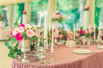 pink candles on a table in a restaurant in a romantic place
