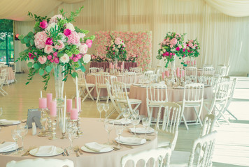 a reflective table at a wedding banquet, a table with candles, flowers and a beautiful tableware