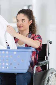 young woman folding the clothes