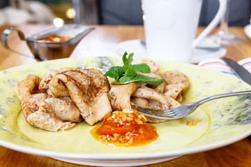 Russian pancakes with jam are on the plate. Breakfast