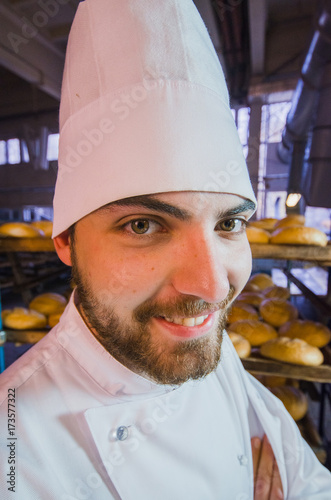 "Baker. Bakery. A young handsome worker at a bakery on the ...