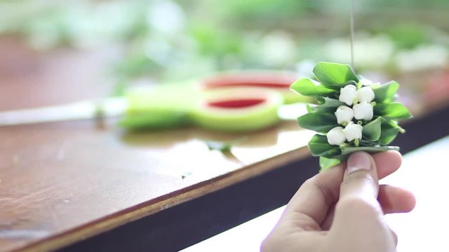 Thai Woman hands made flowers garland with jasmine for mothers day, Thais culture tradition that teaching education of Thailand.