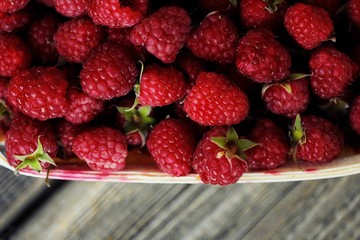 Delicious fresh raspberry in the wooden basket