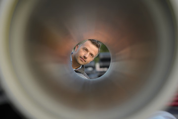 man inspecting a pipe