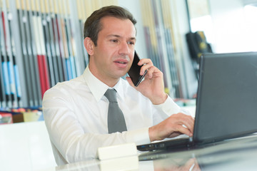 a businessman on the phone working at the office