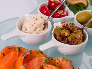 Snack set. Oktoberfest food frame concept. Variety of humus, olives, vegetables, cheese and sauces on white background. Top view