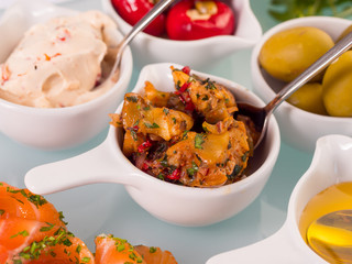 Snack set. Oktoberfest food frame concept. Variety of humus, olives, vegetables, cheese and sauces on white background. Top view