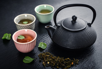 Obraz na płótnie Canvas Green tea in cast-iron teapot