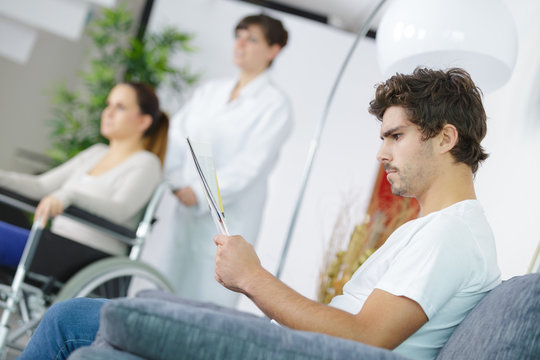 patients in doctors waiting room