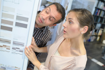 male and female collegues discussing colour samples