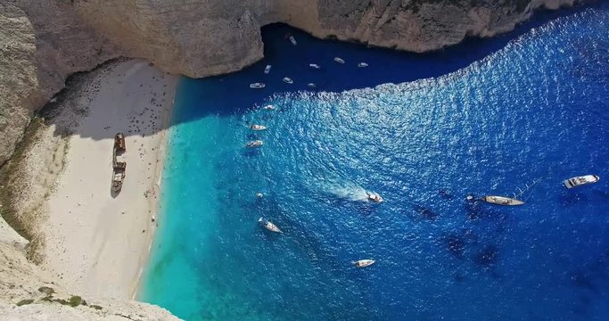 Aerial flight with drone over the Navagio (Shipwreck) Beach in Zakynthos island, Greece. Navagio Beach is a popular attraction among tourists visiting the island of Zakynthos