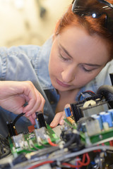 girl wiorking on a printed circuit board
