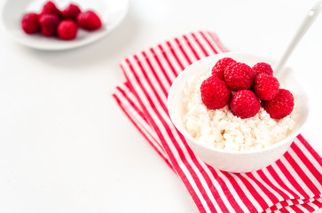 Fresh cottage cheese with juicy berries raspberries, dietary breakfast for summer time selective focus