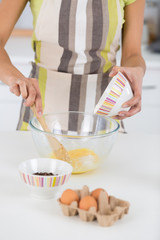 cook breaking an egg into the bowl