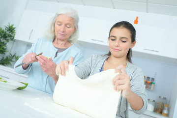 Fototapeta premium senior nanny cooking with girl