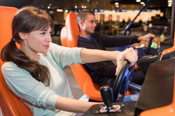 young couple computer playing car racing video game