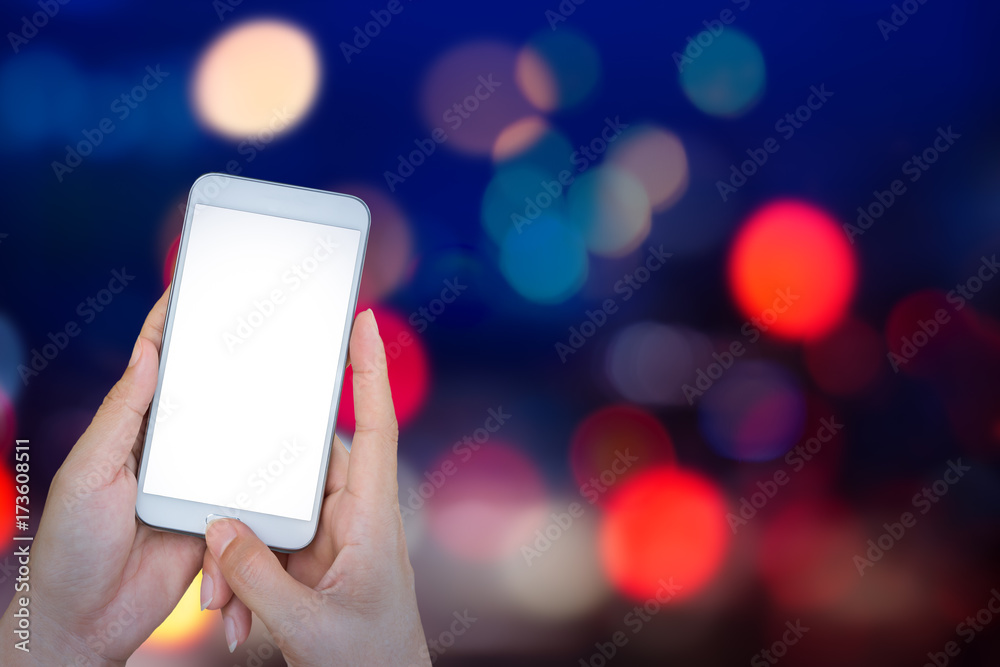 Poster hand holding smart phone with abstract lights bokeh on black background