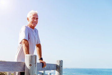 Fototapeta premium Man standing on beach in sports wear