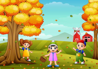 Obraz na płótnie Canvas Happy children playing with wooden basket in farm landscape 