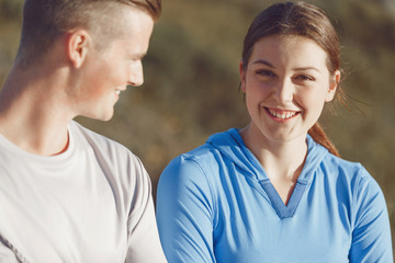 Young couple on beach in sportwear