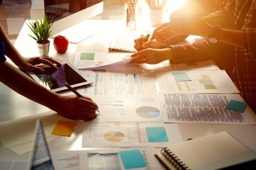 Team of young asian people discussing new business plan during a meeting in office.