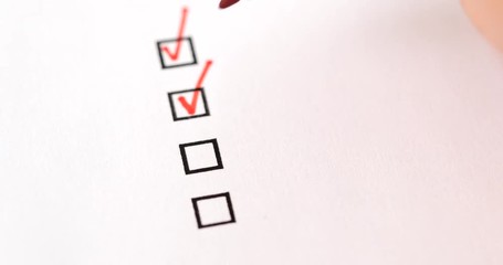 Hands check all the check box with red marker