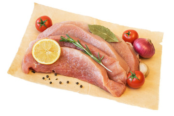 Bay leaf, tomatoes, Basil with pieces of raw pork on paper isolated on white background.