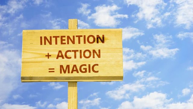 Intention plus action equal magic. Words on a wooden sign against time lapse clouds in the blue sky. 