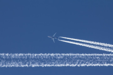 Passengers jet is flying in perfect blue sky