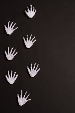 Black Halloween Background with White Skeleton Hands