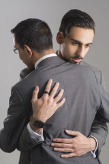 Business Partner Consoling Another Isolated Over Gray Background