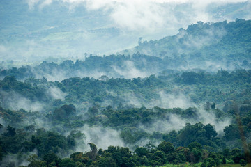Obraz premium Aerial view of hills in rural covered with fog in the morning