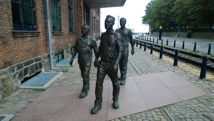 Sculpture of workers hurrying to the shipyard in the city Helsingor in Denmark