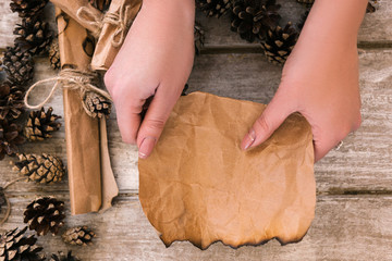 Decoration process top view. Festive mood. New Year seasonal greetings preparation background in focus on foreground, unrecognizable female, creativity concept