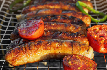 Grilling sausages on barbecue grill. Selective focus.